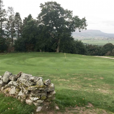 The stone walls on the 4th hole at The moody skies over Bridge of Allan Golf Course.