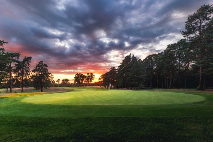 A photo at sunrise of the 11th hole at Woking Golf Club.